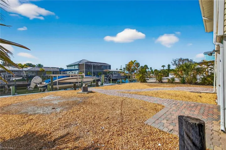 View of yard featuring a water view, boat lift, and a dock