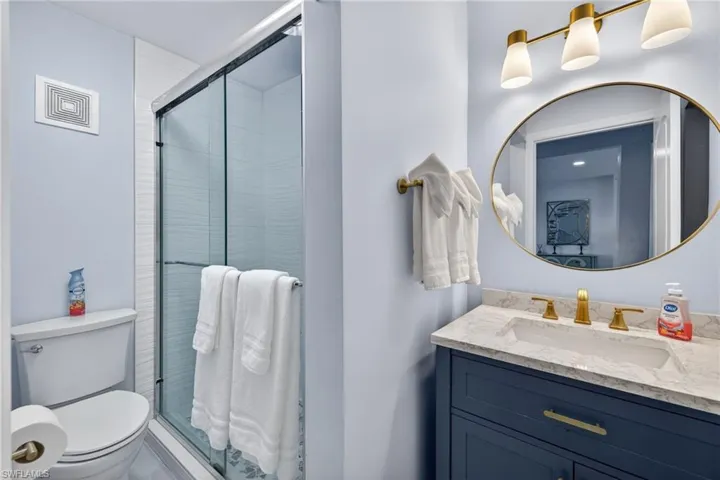Bathroom featuring vanity and a shower stall
