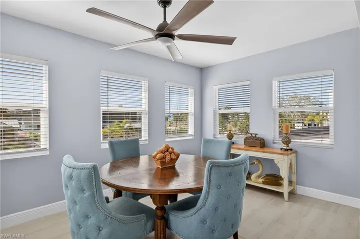 Dining area featuring plenty of natural light, a ceiling fan, and tile floors