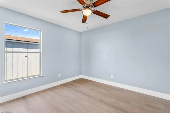 Spare room with light wood-style floors and ceiling fan