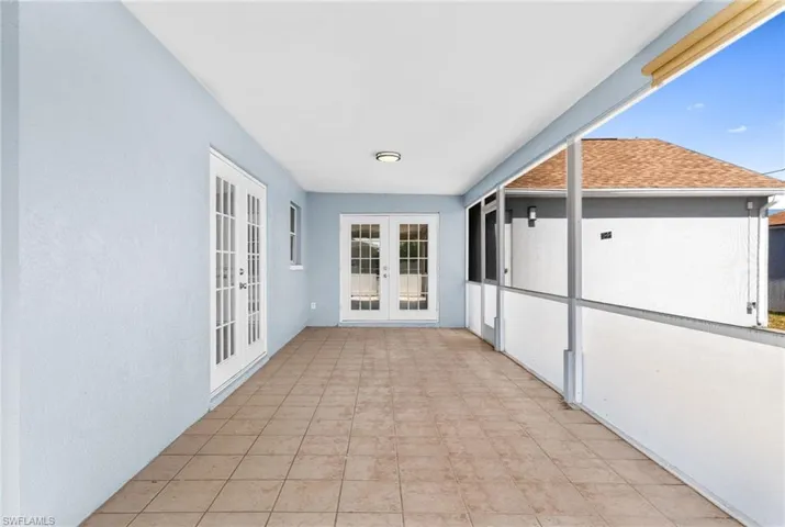 Unfurnished sunroom with french doors