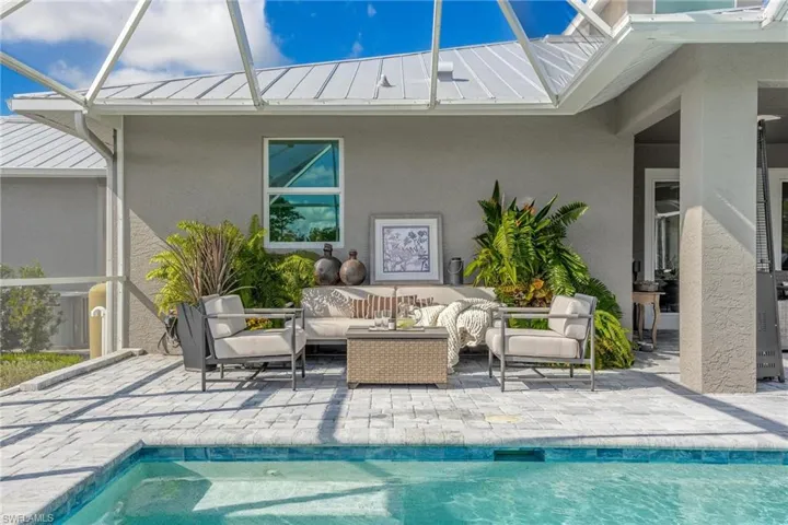 View of pool featuring outdoor lounge area.