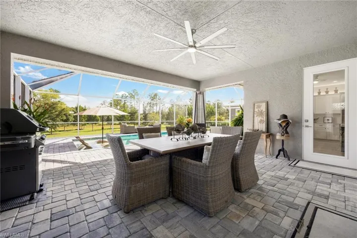 View of screened lanai featuring ceiling fan and a lanai, plenty of room under truss to get away from the sun or afternoon summer showers.