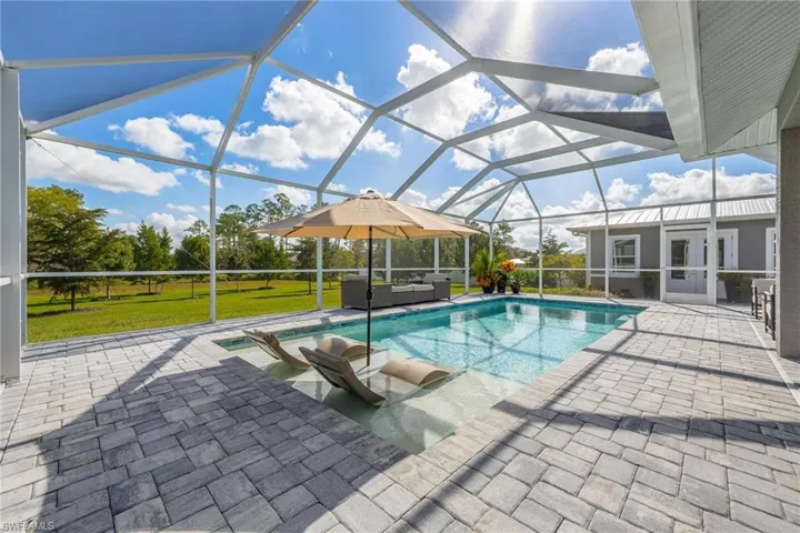 View of swimming pool with a patio, a wonderful space for relaxing and reading!
