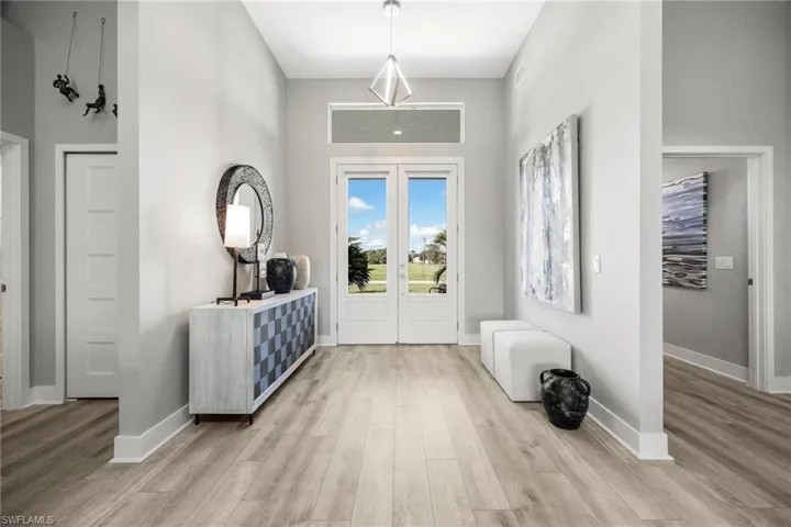 Foyer featuring light hardwood / wood-style floors and french doors