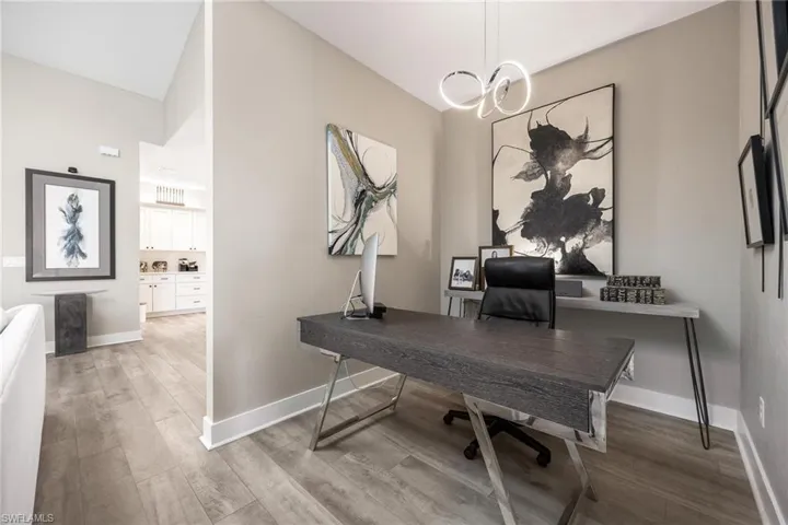 Office featuring a notable chandelier