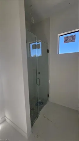 Full bathroom featuring baseboards and a stall shower