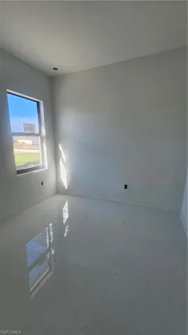 Unfurnished room with baseboards