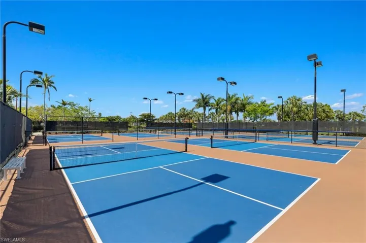 View of tennis court with community basketball court