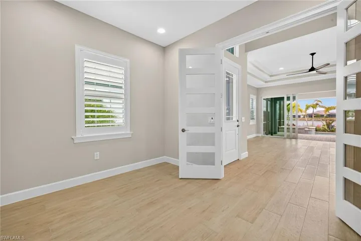 Unfurnished room with light wood-type flooring, a ceiling fan, plenty of natural light, french doors, and recessed lighting