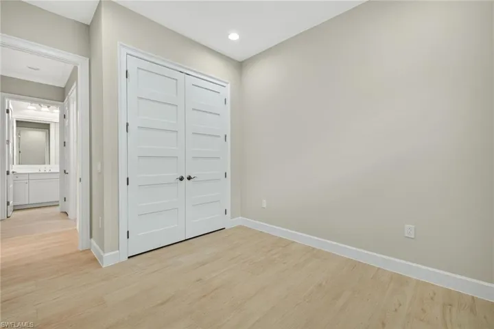 Unfurnished bedroom with light wood finished floors, a closet, and recessed lighting