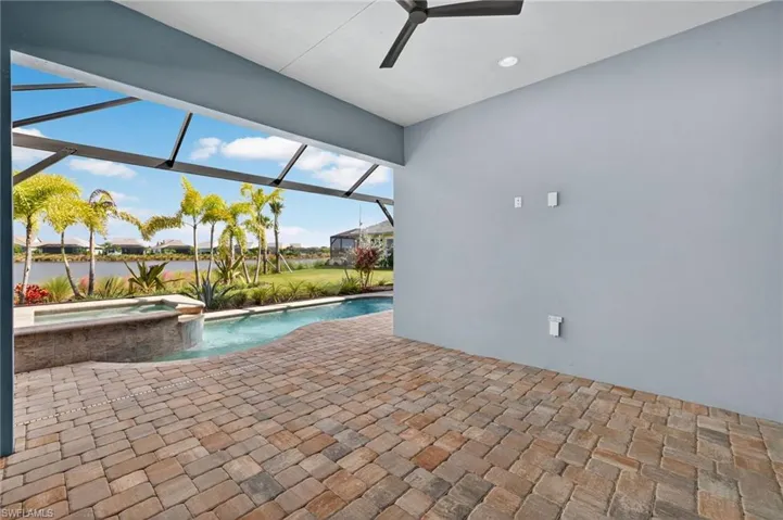 View of swimming pool featuring a patio, a sunroom, glass enclosure, and a pool with connected hot tub