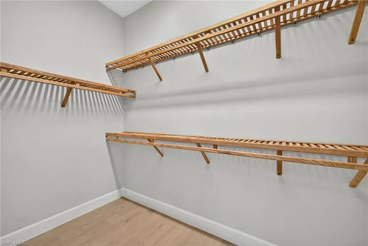 Spacious closet featuring light wood-type flooring