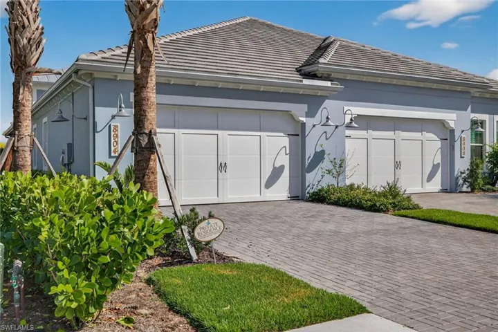 Garage featuring decorative driveway