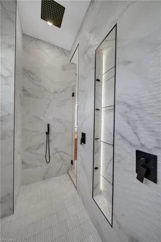 Bathroom with a marble finish shower