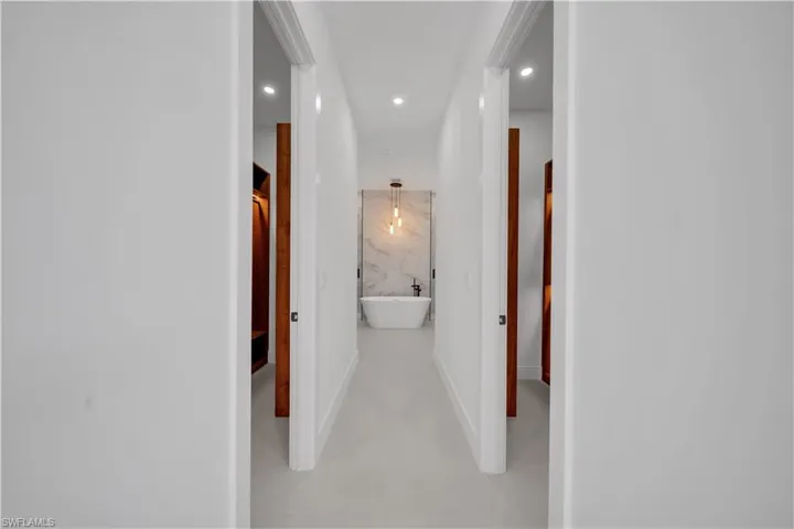 Corridor with recessed lighting and finished concrete floors