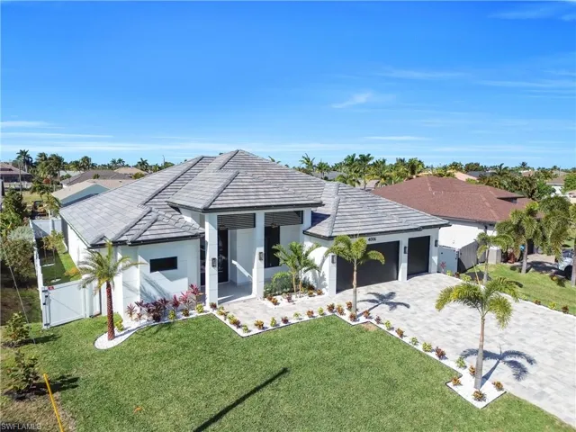 View of front of house featuring a gate, decorative driveway, stucco siding, and a garage