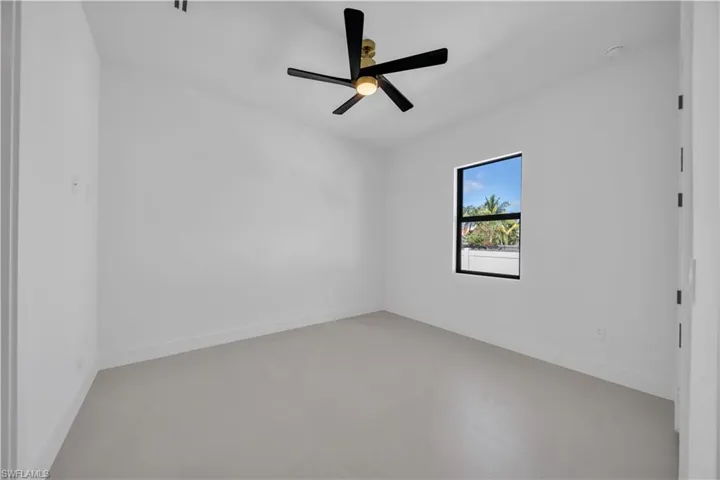 Spare room with baseboards and ceiling fan