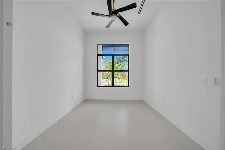 Unfurnished room featuring concrete flooring and ceiling fan