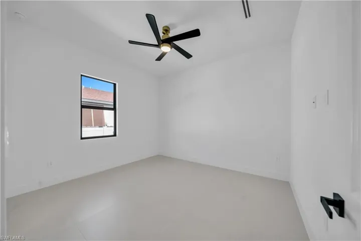 Spare room with baseboards and a ceiling fan