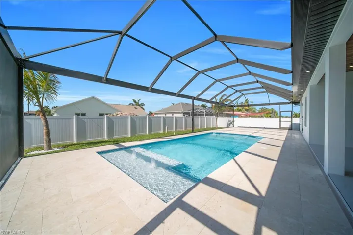 View of swimming pool featuring a sunroom, a lanai, patio surround, and a fenced backyard