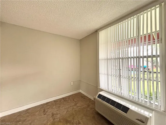 Spare room with a textured ceiling and stone finish floors