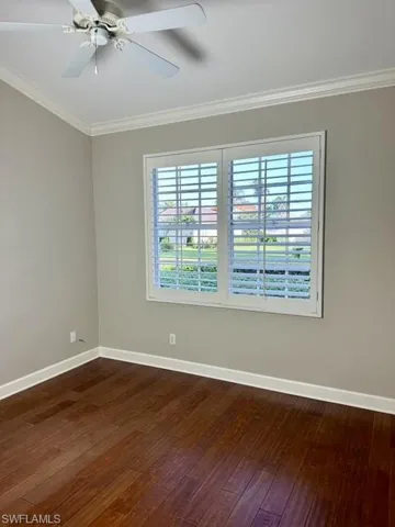 Spare room with ceiling fan, ornamental molding, and hardwood / wood-style flooring