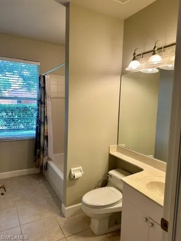 Bathroom featuring plenty of natural light, an inviting chandelier, and shower with separate bathtub