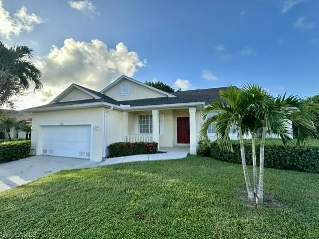 Single story home with a garage and a front yard
