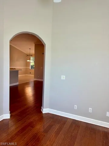 Empty room featuring dark hardwood / wood-style floors