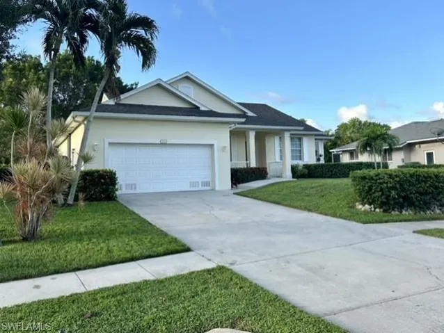 Ranch-style home with a garage and a front lawn