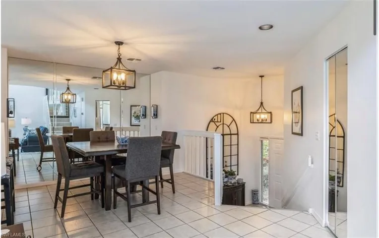 Dining area with a chandelier and light tile patterned floors