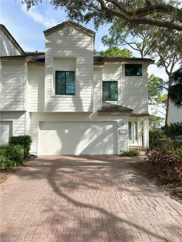 View of front facade with decorative driveway and an attached garage