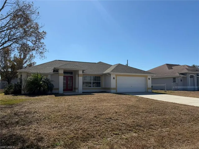 Ranch-style house with french doors, concrete driveway, stucco siding, a garage, and a shingled roof