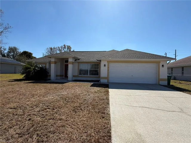 View of front of property featuring stucco siding, concrete driveway, an attached garage, and roof with shingles