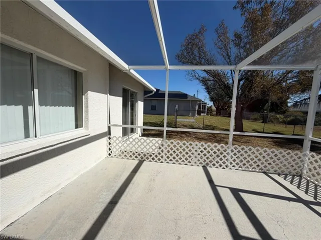Unfurnished sunroom featuring a patio
