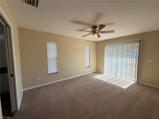 Unfurnished bedroom featuring a ceiling fan and carpet flooring