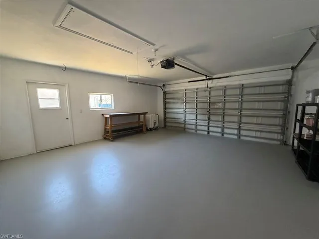 Garage featuring a garage door opener