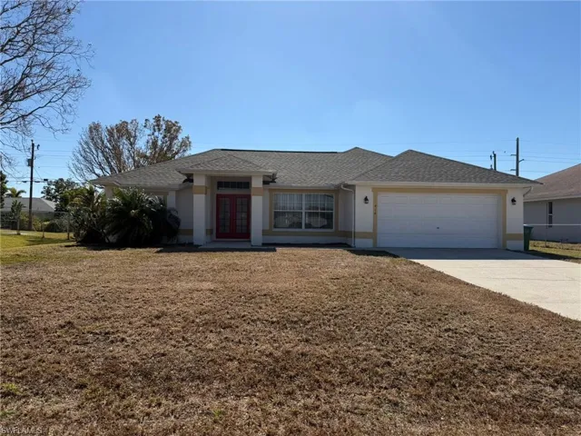 Single story home with a shingled roof, french doors, driveway, stucco siding, and an attached garage