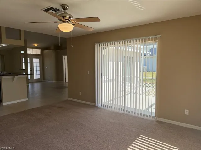 Spare room with light colored carpet and ceiling fan