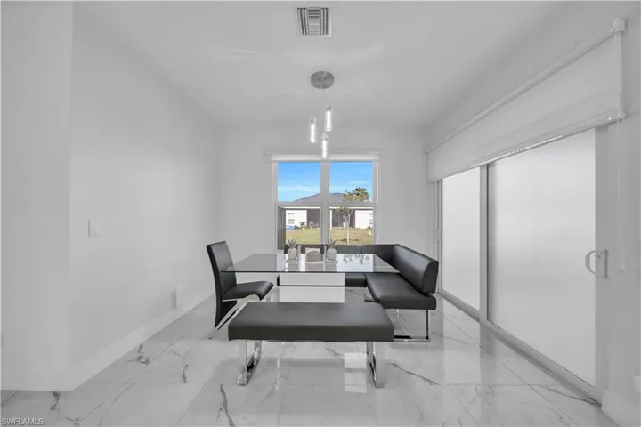 Dining space featuring light marble finish floors