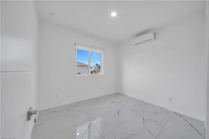 Spare room with light marble finish flooring and recessed lighting