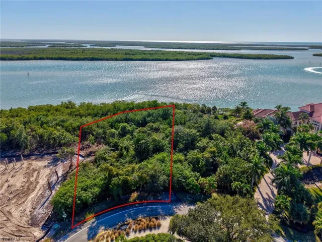 Aerial overview of property's location with property parcel outlined and a large body of water