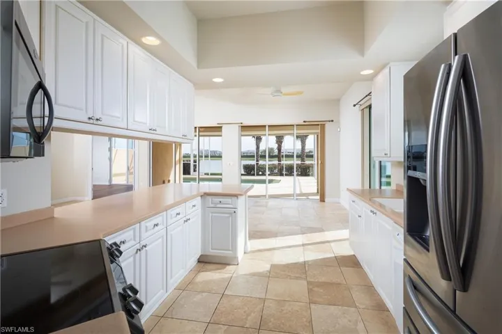 Kitchen with gorgeous view of pool and lake.