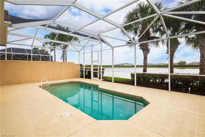 Pool featuring a patio, a water view, and a lanai