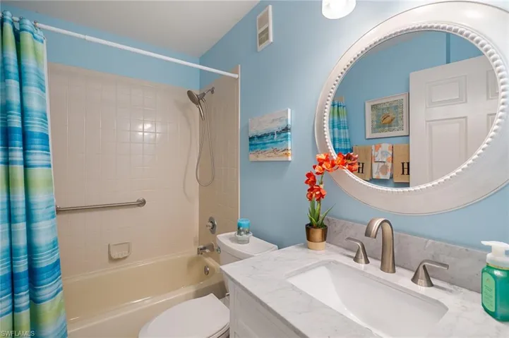 Full bathroom with vanity, toilet, and shower / tub combo