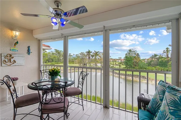 Sunroom / solarium featuring a water view