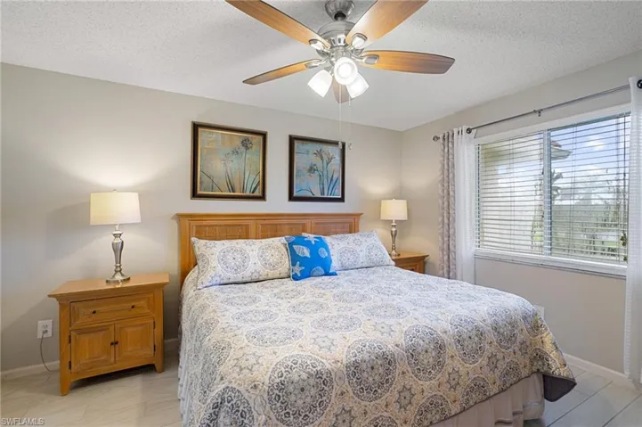 Bedroom featuring ceiling fan and a textured ceiling