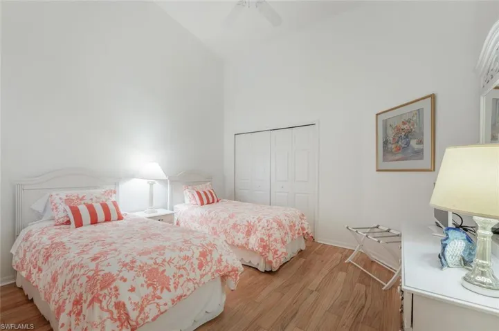 Bedroom with high vaulted ceiling, and a ceiling fan