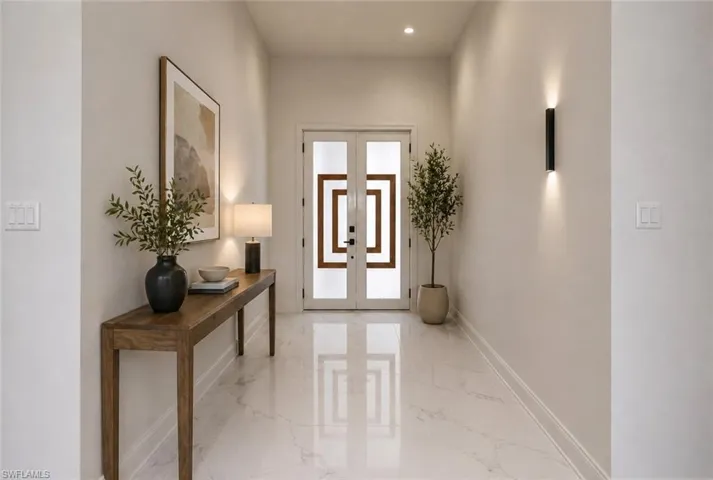 Entryway featuring large format marble-look tile flooring. Image digitally enhanced and virtually altered; actual property condition may differ.